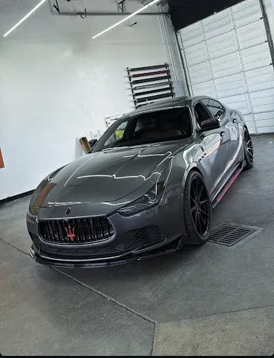 Dark gray sedan inside the Tint City workshop